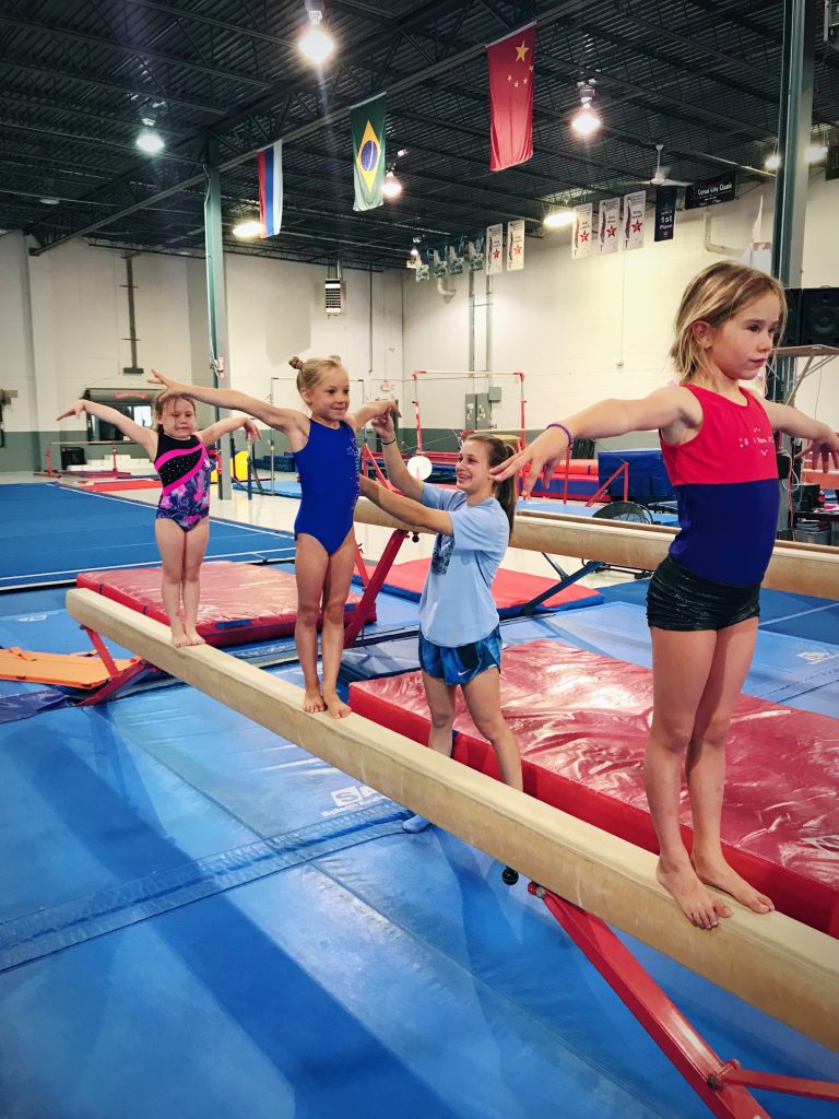 euro stars gymnastics plymouth mi gymnast on beam with coaches